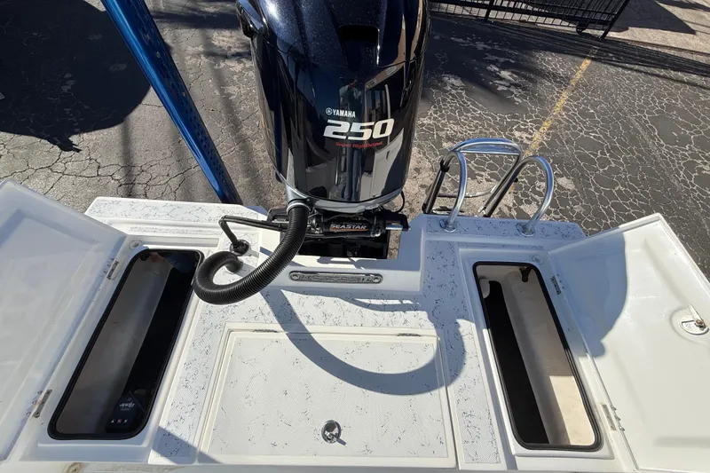 Slide: The Image of 2018 Shallow Sport 24 Modified V boat with Yamaha 250 engine, open storage compartments. - 27