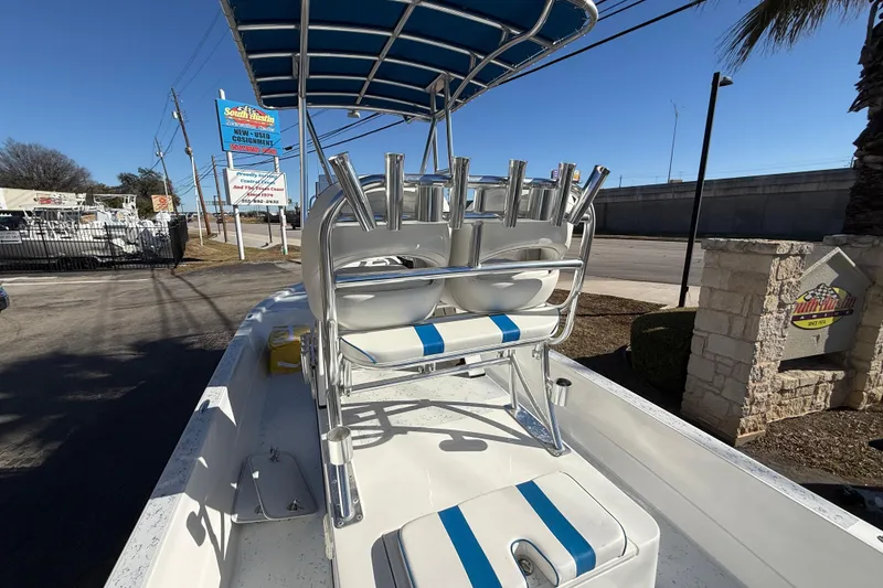 Slide: The Image of 2018 Shallow Sport 24 Modified V boat with blue-striped seating and rod holders. - 28