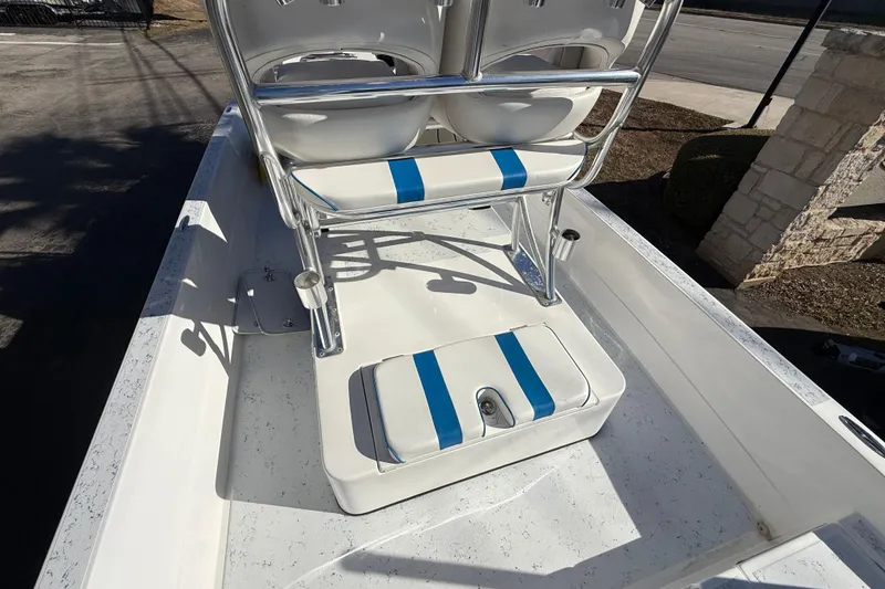 Slide: The Image of 2018 Shallow Sport 24 Modified V boat interior with blue-striped seating and console. - 29
