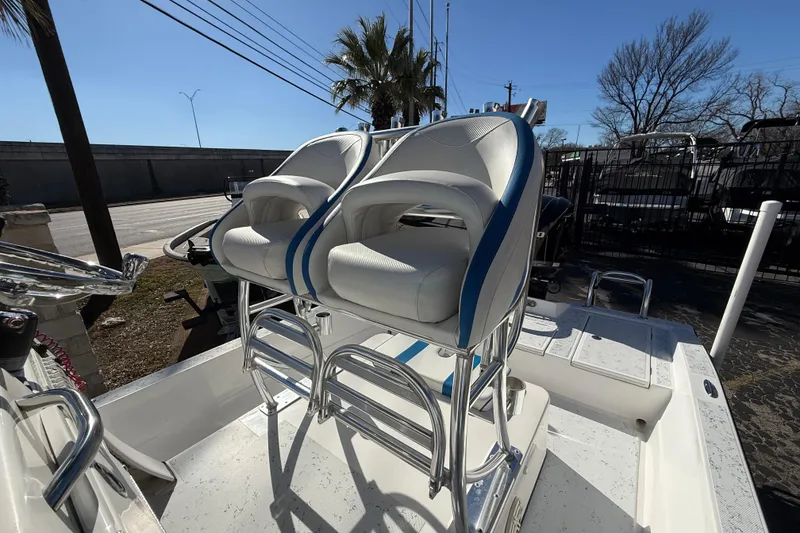 Slide: The Image of 2018 Shallow Sport 24 Modified V boat with dual white and blue seats. - 33