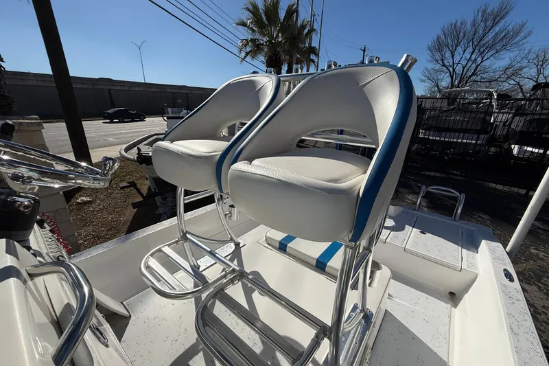 Slide: The Image of 2018 Shallow Sport 24 Modified V boat with dual white and blue seats. - 34