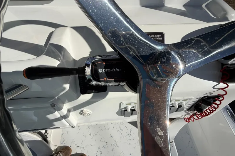 Slide: The Image of 2018 Shallow Sport 24 Modified V boat steering wheel and controls. - 38