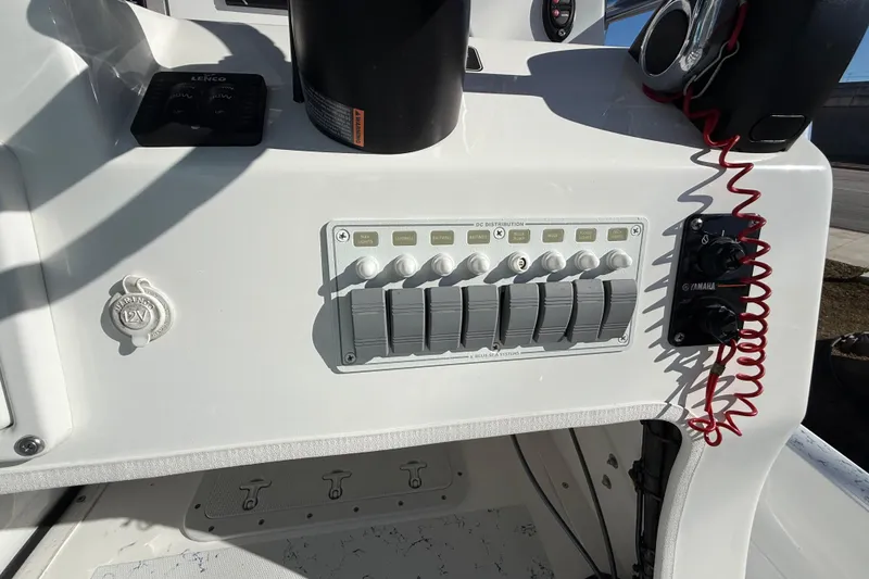 Slide: The Image of Control panel of a 2018 Shallow Sport 24 Modified V boat with switches and Yamaha controls. - 39