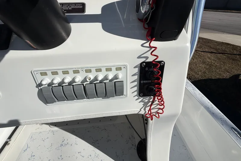 Slide: The Image of Control panel of a 2018 Shallow Sport 24 Modified V boat with switches and safety lanyard. - 41