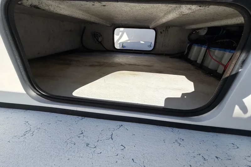 Slide: The Image of 2018 Shallow Sport 24 Modified V boat storage compartment with battery setup. - 43