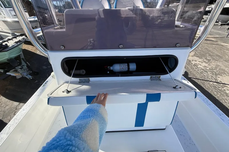 Slide: The Image of 2018 Shallow Sport 24 Modified V boat console with storage compartment open. - 47