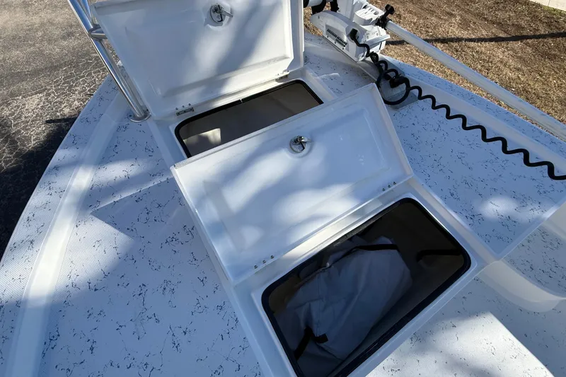 Slide: The Image of 2018 Shallow Sport 24 Modified V boat with open storage compartments on deck. - 49