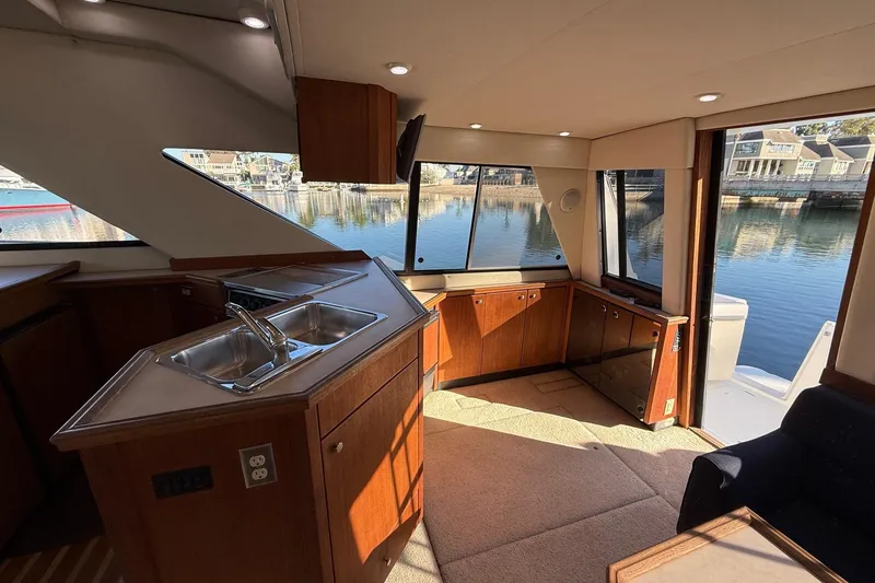 Slide: The Image of Interior of 1995 Bayliner 39 Motoryacht with kitchen and waterfront view. - 10