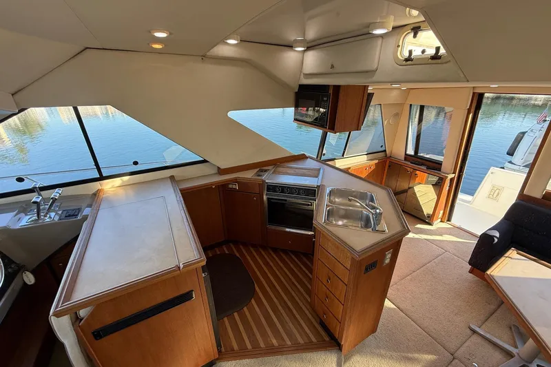 Slide: The Image of Interior of a 1995 Bayliner 39 Motoryacht with kitchen and seating area. - 11