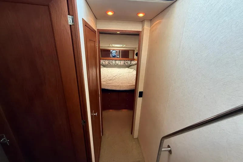 Slide: The Image of Interior hallway of 1995 Bayliner 39 Motoryacht leading to cozy bedroom. - 13