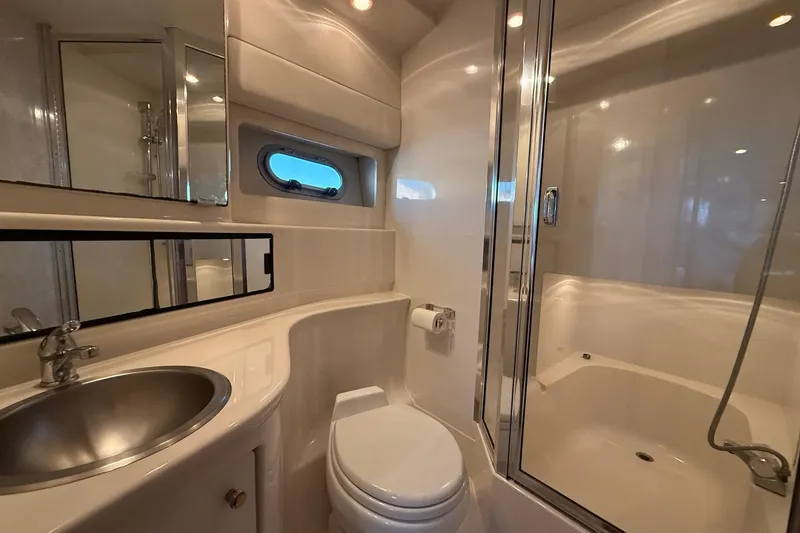 Slide: The Image of Luxurious bathroom in 1995 Bayliner 39 Motoryacht with shower, sink, and porthole window. - 17