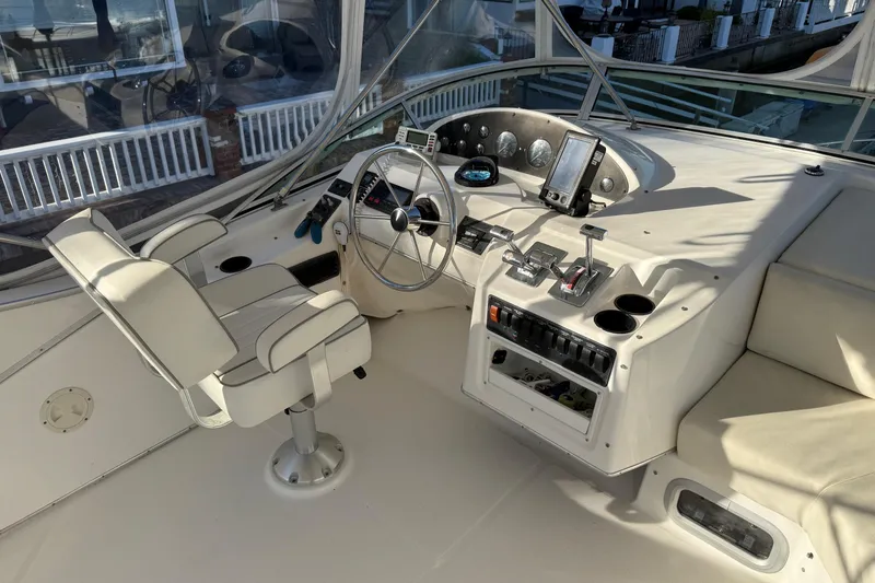 Slide: The Image of 1995 Bayliner 39 Motoryacht helm with steering wheel, controls, and navigation equipment. - 22