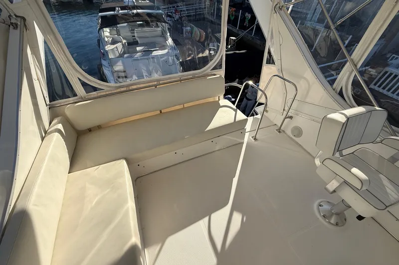Slide: The Image of 1995 Bayliner 39 Motoryacht interior with seating and helm, docked at marina. - 23