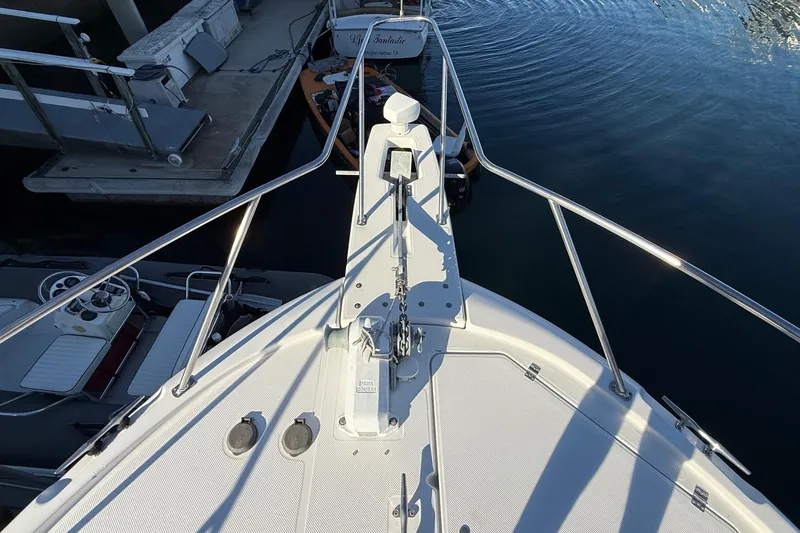 Slide: The Image of Bow view of 1995 Bayliner 39 Motoryacht docked at marina. - 24