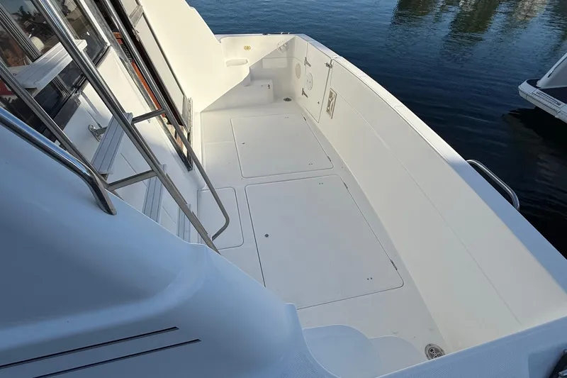 Slide: The Image of 1995 Bayliner 39 Motoryacht deck with railing, overlooking calm water. - 28