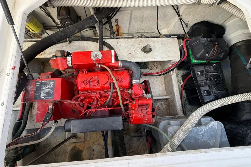 Slide: The Image of Engine compartment of a 1995 Bayliner 39 Motoryacht, featuring a red engine and wiring. - 31