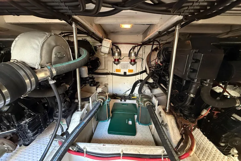 Slide: The Image of Engine room of a 1995 Bayliner 39 Motoryacht, showcasing mechanical components and systems. - 32