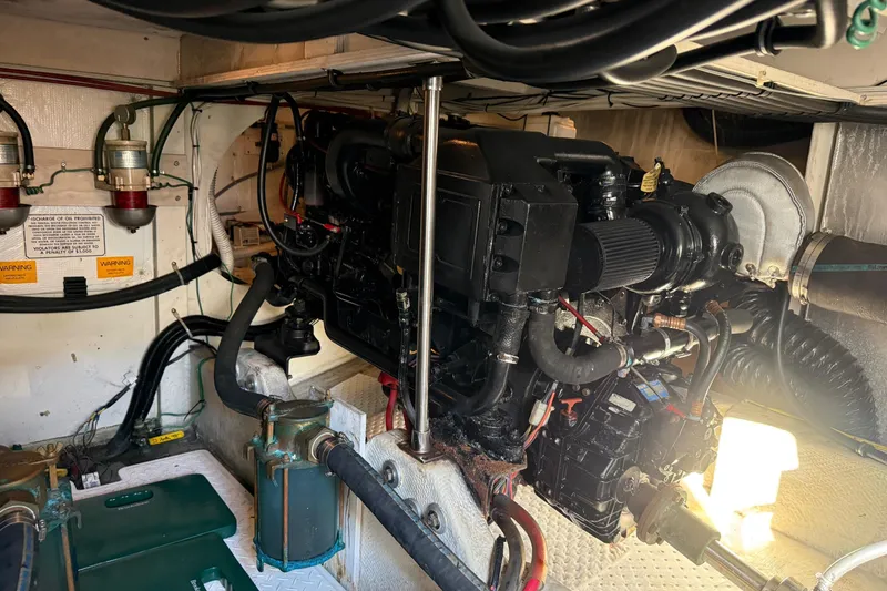 Slide: The Image of Engine room of a 1995 Bayliner 39 Motoryacht, showcasing mechanical components and wiring. - 34