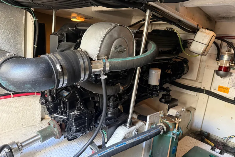 Slide: The Image of Engine room of a 1995 Bayliner 39 Motoryacht, showcasing mechanical components. - 35