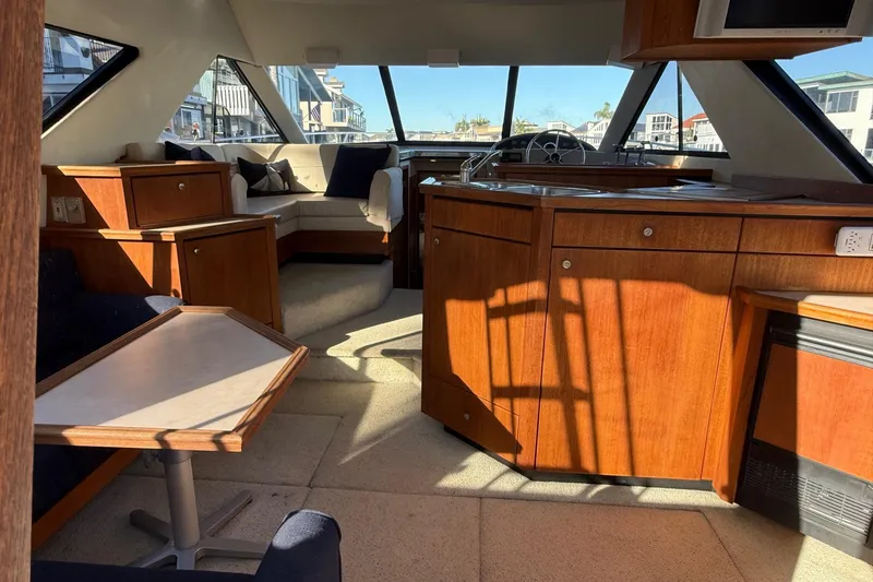 Slide: The Image of Interior of 1995 Bayliner 39 Motoryacht with wood cabinetry and seating area. - 4