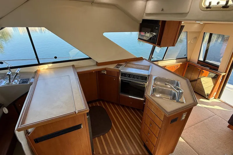 Slide: The Image of Interior of 1995 Bayliner 39 Motoryacht kitchen with wood cabinetry and modern appliances. - 9