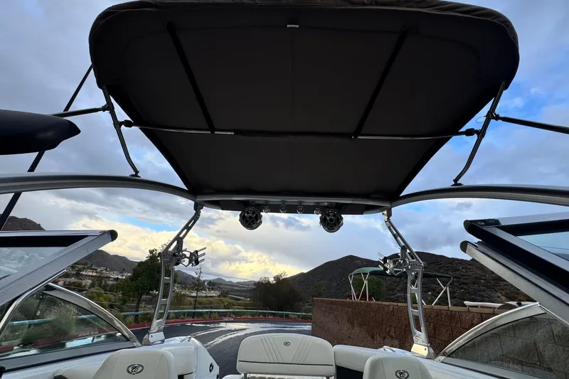 Slide: The Image of 2014 Cobalt 262 WSS boat interior with canopy, scenic mountain backdrop. - 11