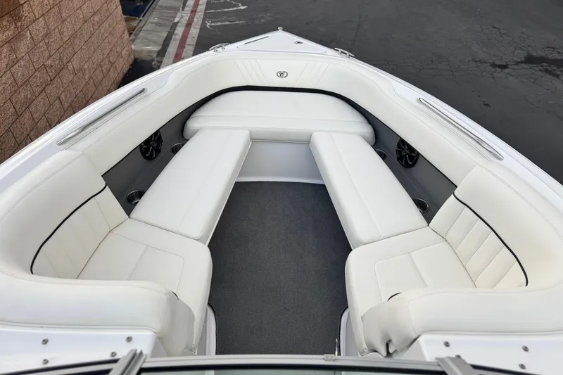 Slide: The Image of 2014 Cobalt 262 WSS boat interior with white cushioned seating and sleek design. - 18