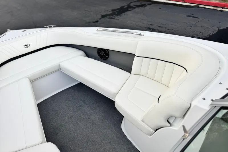 Slide: The Image of 2014 Cobalt 262 WSS boat interior with white cushioned seating and sleek design. - 20