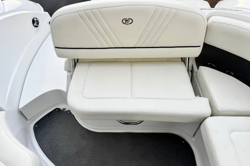 Slide: The Image of 2014 Cobalt 262 WSS boat interior with white cushioned seating. - 23