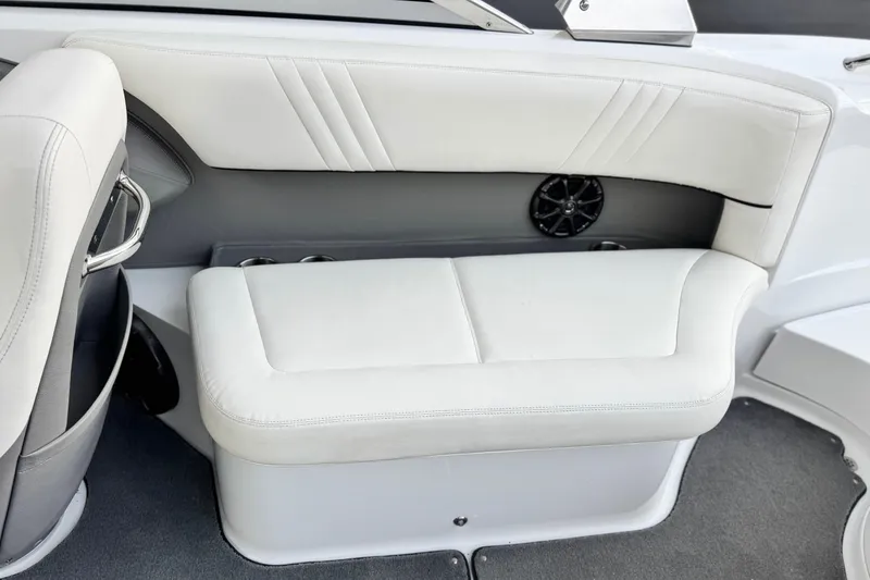 Slide: The Image of 2014 Cobalt 262 WSS boat interior with white cushioned seating and speaker. - 24