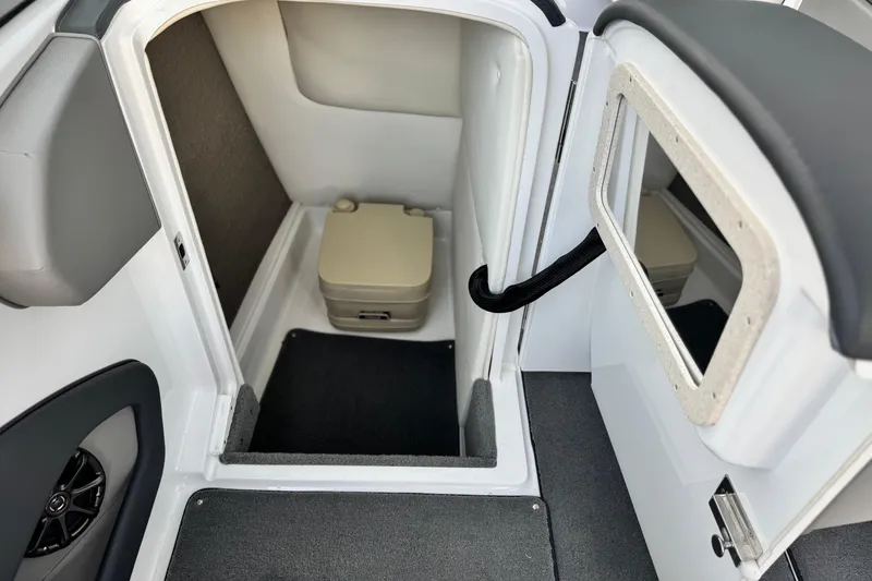 Slide: The Image of 2014 Cobalt 262 WSS boat interior with compact toilet and mirror. - 26