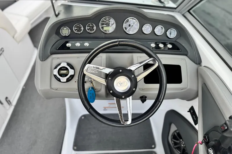 Slide: The Image of 2014 Cobalt 262 WSS boat dashboard with steering wheel and control panel. - 28