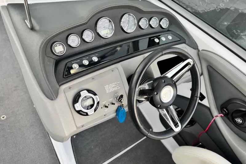 Slide: The Image of 2014 Cobalt 262 WSS boat dashboard with steering wheel and instrument panel. - 29