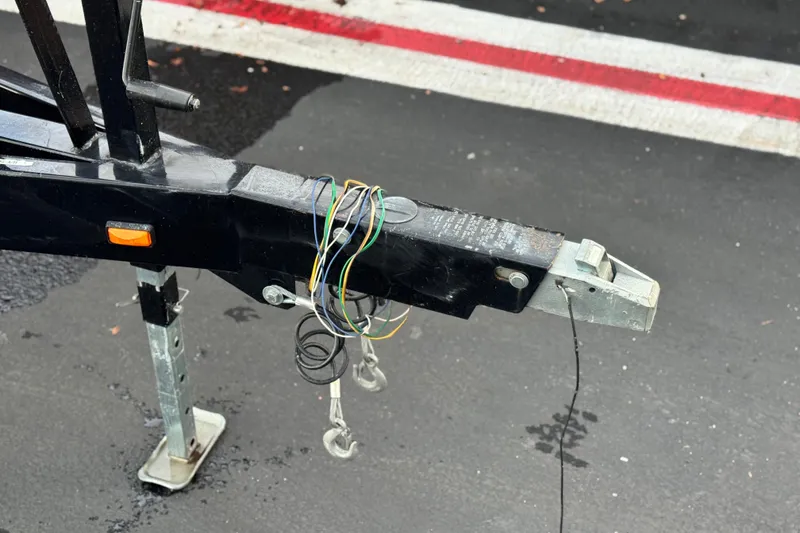 Slide: The Image of Trailer hitch with exposed wiring on a 2014 Cobalt 262 WSS boat trailer. - 31