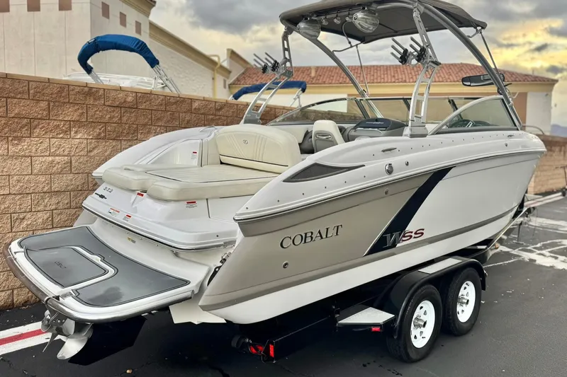 Slide: The Image of 2014 Cobalt 262 WSS boat on trailer, parked outdoors with overcast sky. - 5