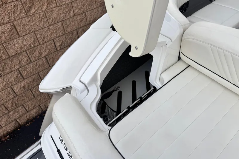 Slide: The Image of 2014 Cobalt 262 WSS boat with open storage compartment and white seating. - 8