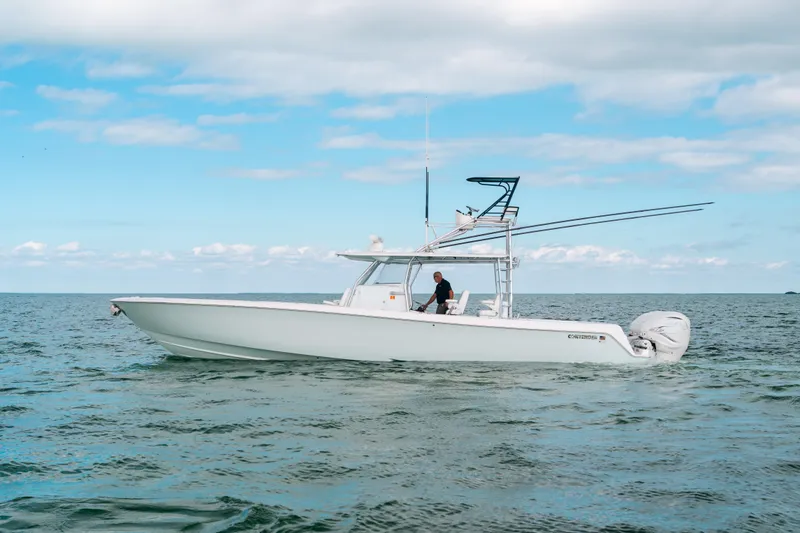 The Image of 2021 Contender 44 ST boat on open water under blue sky. - 0