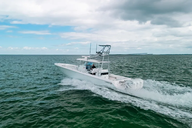 Slide: The Image of 2021 Contender 44 ST boat cruising on open water under cloudy sky. - 10