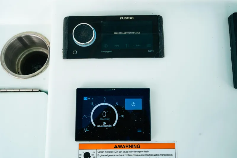 Slide: The Image of Control panel of 2021 Contender 44 ST boat with Fusion and Seakeeper displays. - 14