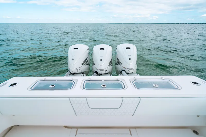 Slide: The Image of 2021 Contender 44 ST boat with triple outboard engines on open water. - 17