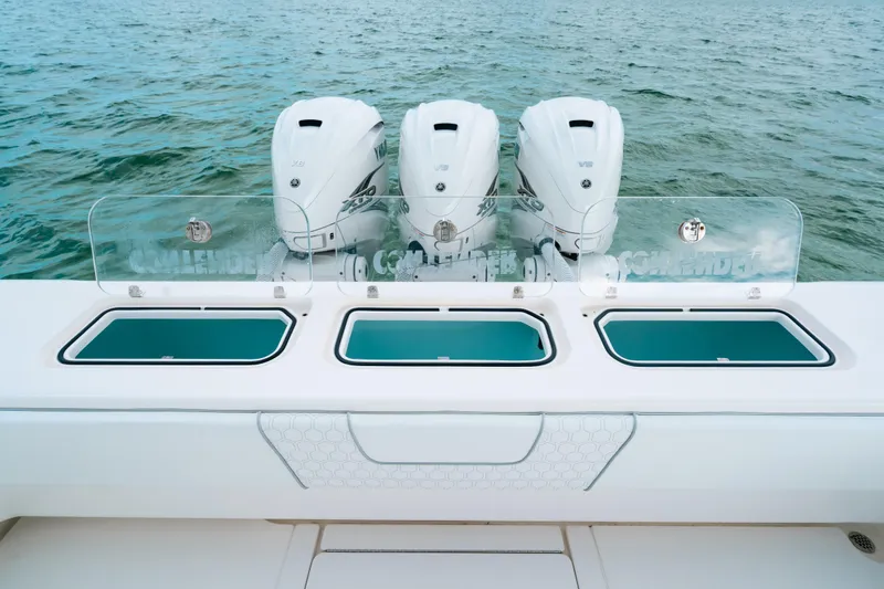 Slide: The Image of 2021 Contender 44 ST boat with triple outboard engines on open water. - 19