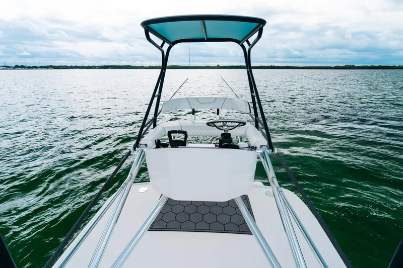 Slide: The Image of 2021 Contender 44 ST boat on open water, featuring sleek design and modern helm. - 28