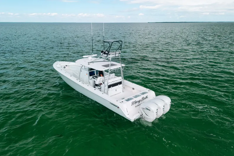 Slide: The Image of 2021 Contender 44 ST boat on open water, featuring dual outboard engines. - 3