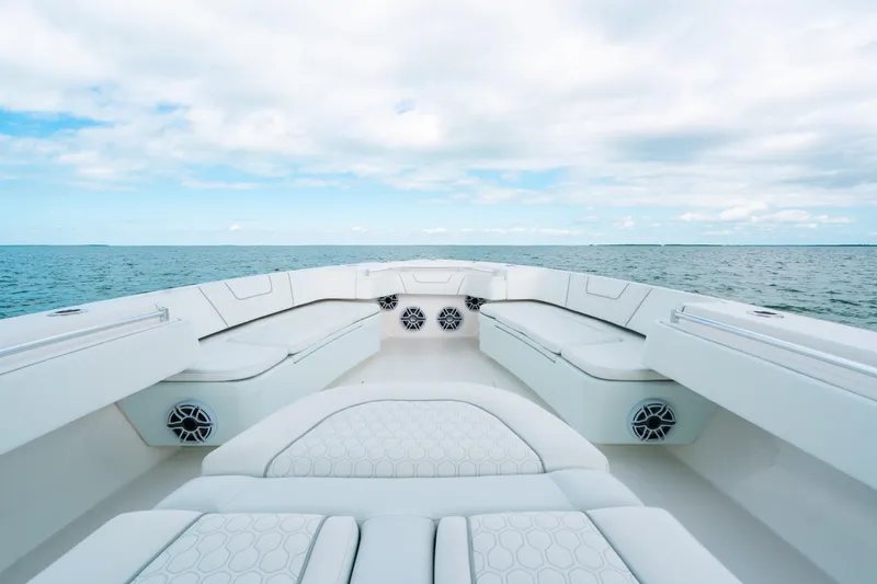 Slide: The Image of 2021 Contender 44 ST boat interior with white seating, ocean view, and speakers. - 31