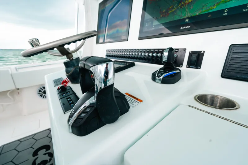 Slide: The Image of 2021 Contender 44 ST boat helm with advanced controls and Garmin displays. - 37