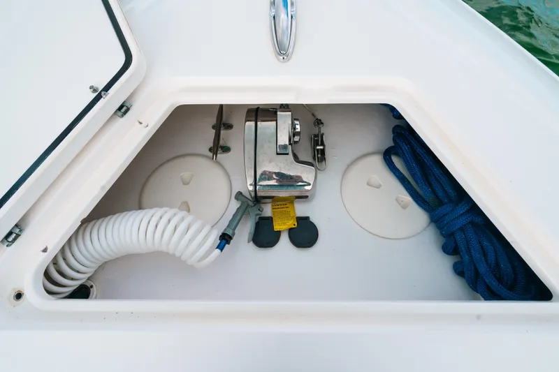 Slide: The Image of Anchor storage compartment on 2021 Contender 44 ST boat with coiled rope and hose. - 39