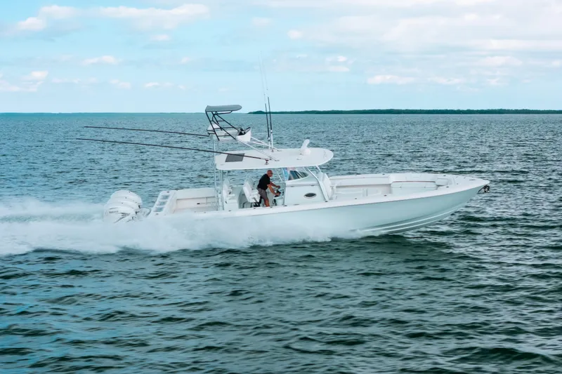 Slide: The Image of 2021 Contender 44 ST boat cruising on open water under a cloudy sky. - 4