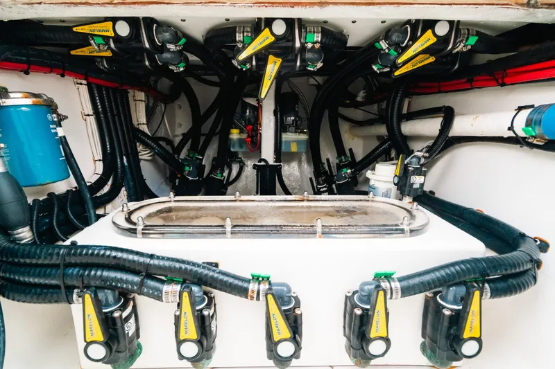 Slide: The Image of Engine compartment of 2021 Contender 44 ST boat, showcasing complex wiring and components. - 40