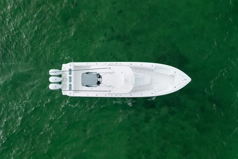 Slide: The Image of Aerial view of 2021 Contender 44 ST boat on green water. - 9