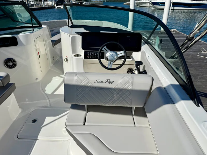 Slide: The Image of The image shows the cockpit of a 2026 Sea Ray SDX 230 Outboard with a sleek steering wheel. - 15